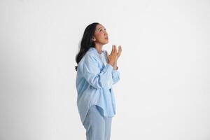 A sad Asian woman wearing a blue shirt looks stressed and depressed, isolated white background. photo