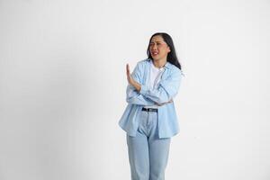 Young Asian woman isolated on white background, looks serious, gesturing decline or NO sign by her hand, frightened and nervous. photo