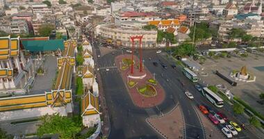 An aerial view of Red Giant Swing and Suthat Thepwararam Temple at sunset scene, The most famous tourist attraction in Bangkok, Thailand video