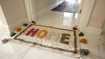 a rug with the word home written on it is on the floor in a hallway video