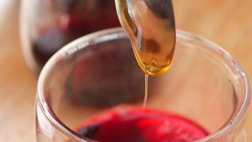 pouring honey in a cup of tea on table video