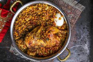 Arabic Meat Majboos with dal, daal, dhal, kentil and lemon served in dish isolated on red mat top view on table arabic food photo