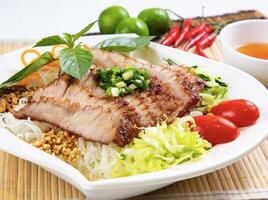 Lemongrass Pork Neck with Lemon with chilli sauce served in dish isolated of table top view fast food snacks photo