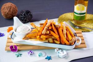 Fisherman Crisp fries served in tray isolated on wooden board side view fried small fishesFisherman Crisp fries served in tray isolated on wooden board side view fried small fishes photo