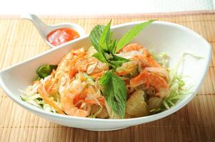 Yuzu Shrimp Salad with chilli sauce served in dish isolated on table green food photo