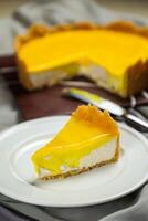 Fresh Lemon Cheesecake slice with fork and knife served in plate isolated on napkin top view cafe bake food photo