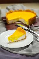 Fresh Lemon Cheesecake slice with fork and knife served in plate isolated on napkin top view cafe bake food photo