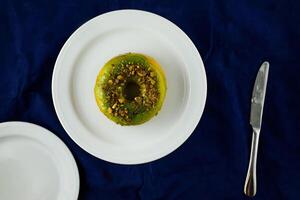 Lemon Pistachio Donut served in plate Isolated on background top view of baked breakfast food photo