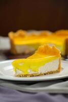 Fresh Lemon Cheesecake slice with fork and knife served in plate isolated on napkin top view cafe bake food photo