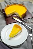 Fresh Lemon Cheesecake slice with fork and knife served in plate isolated on napkin top view cafe bake food photo