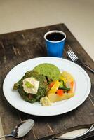 Garlic Chicken With Rice and Veg served in plate with cold drink, spoon and fork isolated on wooden board side view of thai food photo