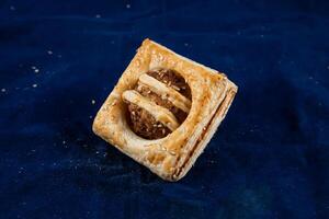 Chicken Crumb Puff isolated on blue background side view of savory snack food photo