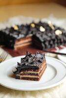 Chocolate Ganache cake slice served in plate with knife isolated on napkin top view of cafe bake food photo