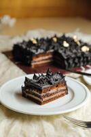 Chocolate Ganache cake slice served in plate with knife isolated on napkin top view of cafe bake food photo