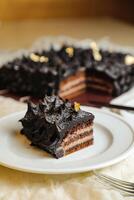Chocolate Ganache cake slice served in plate with knife isolated on napkin top view of cafe bake food photo