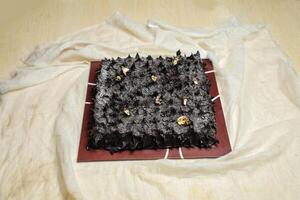 Chocolate Ganache cake isolated on napkin top view of cafe bake food photo