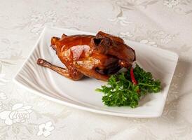 braised bbq pigeon served dish isolated on background top view of hong kong chinese food photo