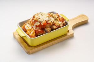 Baked Pork Chop Rice with Fresh Tomato and Pineapple served in dish isolated on wooden table side view of hong kong fast food photo