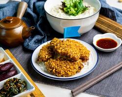 Typhoon Shelter Chicken Wing with fish noodle soup and fish udon served on bowl isolated on napkin side view of fastfood photo
