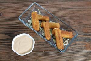 Mozzarella fingers sticks with dip sauce served in dish isolated on table top view of arabic food photo