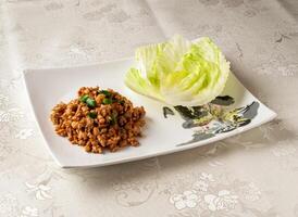 Sichuan Style Black Pork Meat Lettuce Wrap served dish isolated on background top view of hong kong chinese food photo