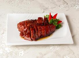 Barbecued Pork King with Honey Sauce served dish isolated on background top view of hong kong chinese food photo