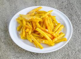 regular llanura papas fritas servido en plato aislado en gris antecedentes lado ver de indio especias y pakistaní comida foto