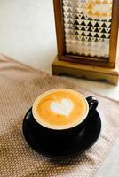 Coffee Latte art served in cup include sugar, milk isolated on napkin side view cafe breakfast hot drink photo