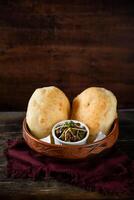 Chole Bhature or channay pathuray and puri served in dish isolated on table top view of indian, bangladeshi and pakistani breakfast food photo