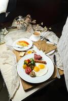 English breakfast with vegetable salad include tomato, potato, lettuce leaf and carrot with tea, coffee, and sweet melon served on food table top view healthy breakfast photo