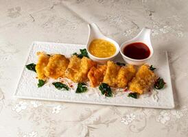 Crispy Grouper Balls with chilli sauce and dip served dish isolated on background top view of hong kong chinese food photo