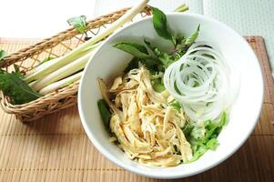 Shredded Chicken Soup Noodles served in bowl isolated on table top view of Soup powder photo