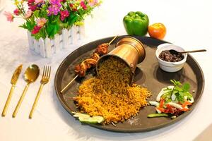 Chicken tikka kabab biryani pulao rice with salad served in dish isolated on table side view of indian spices food photo