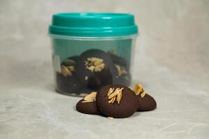 Chocolate cookies biscuits topping with peanut served in box side view of bakery item photo