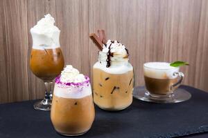 Assortment of specialty cold creamy coffee with chocolate served in jar isolated on table side view of cold dessert beverage on table photo