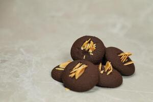Chocolate cookies biscuits topping with peanut served on background side view of bakery item photo