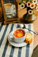 Creamy Tomato Basil Soup served in bowl isolated on napkin side view of chinese soup photo