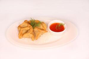 SPINACH FATAYER with chili sauce served in dish isolated on background side view of arab food photo