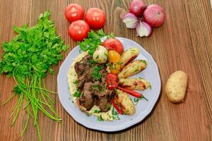 beef tikka kabab bbq boti with potato veggies, tomato, onion and coriander served in dish isolated on table top view of arabic food photo