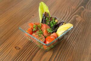 Pickled tomatoes and pickled eggplant with lemon served in dish isolated on wooden table side view of arabic food photo