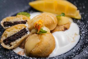 cookie filled cakes with chocolate filling served in dish isolated on table side view of arabic baked dessert food photo