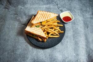 Grilled chicken sandwich with french fries and mayo dip sauce served in plate isolated on background top view of breakfast food indian spices photo