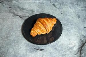 Plain Croissant served in plate isolated on background top view of baked food indian dessert photo