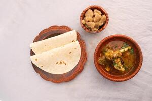 desi breakfast Mutton nalli nihari, Halwa and chapatti served in dish isolated on background top view of bangladesi breakfast photo