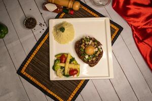 Filet mignon steak with mushroom sauce, dip, black pepper and garlic chilli sauce served in dish isolated on napkin top view on wooden table italian food photo