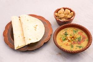 Desi breakfast, haleem, halim, dhaleem, halwa and chapatti served in dish isolated on background top view of bangladesi breakfast photo