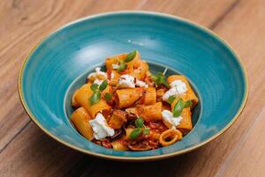 Rigatoni Alla Norma pasta served in plate isolated on table side view of italian fastfood photo