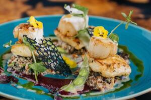 Pan Seared Wild Sea Bass and Scallops served in dish isolated on table side view of Seafood Main Course arabic food photo