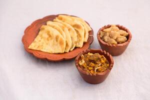 Desi nashta dal chicken, halwa and paratha served in dish isolated on background top view of bangladesi breakfast photo