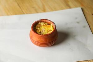 Firni, phirni anf kheer with nuts served in pot isolated on mat top view of indian, bangali and pakistani dessert mithai photo